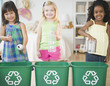 © JGI/Jamie Grill/Blend Images - Children putting recyclable materials into recycling bins