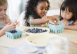 © JGI/Jamie Grill/Blend Images - Girls putting blueberries into bowl together