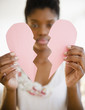 © JGI/Jamie Grill/Blend Images - Black woman holding broken paper heart