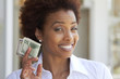© Rolf Bruderer/Blend Images - African American woman holding 50 dollar bill