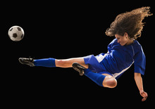 Caucasian Soccer Player Kicking Ball In Mid-air
