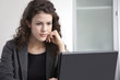 © Peter Dressel/Blend Images - Businesswoman using laptop at desk