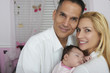© GM Visuals/Blend Images - Hispanic parents holding baby daughter