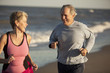 © John Henley/Blend Images - Couple running together on beach