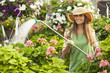 © Mike Kemp/Blend Images - Caucasian woman watering plants