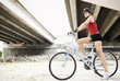 © PBNJ Productions/Blend Images - Hispanic woman riding bicycle in urban area
