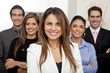 © Andres Rodriguez/Blend Images - Hispanic business people standing together in office
