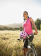 © Erik Isakson/Blend Images - Black biker standing with mountain bike