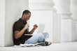 © Mike Kemp/Blend Images - Black college student using laptop outdoors