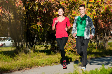 Wall Mural - Young man and woman running