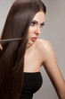 Beautiful Woman combs her Healthy Long Hair. High quality image.