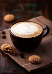 Wall Mural - Cup of cafe au lait and biscotti on the table