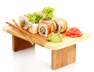 Wall Mural - Tasty rolls served on wooden plate isolated on white