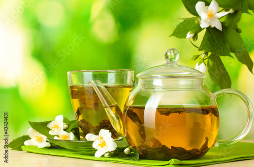 Naklejka na szybę green tea with jasmine in cup and teapot