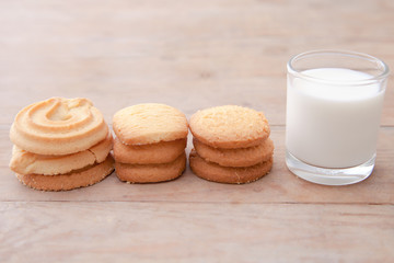 Milk with cookie on wood table