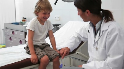 Wall Mural - Doctor testing reaction of a child leg