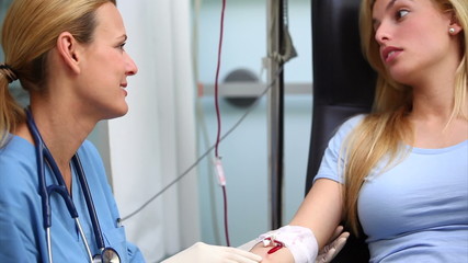 Wall Mural - Nurse smiling to a blood donor