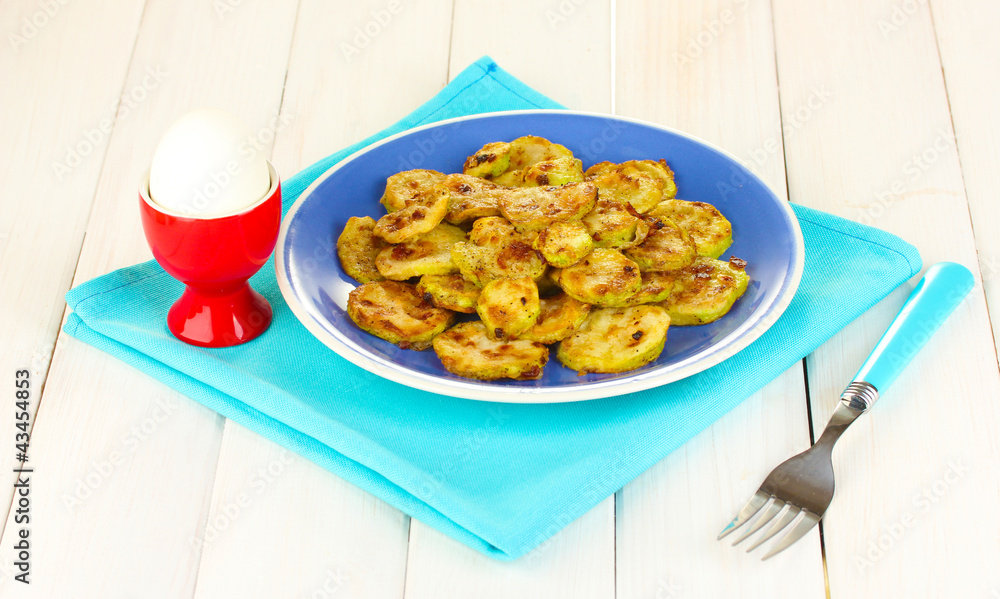 roasted squash in a blue bowl with the egg for breakfast