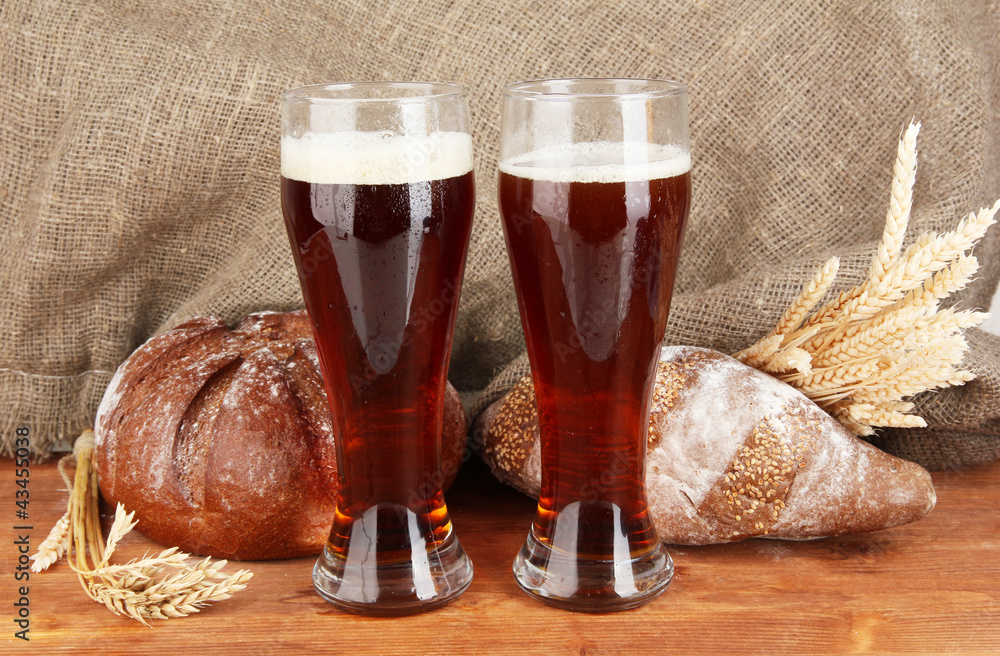 two glasses of kvass with bread on canvas background close-up