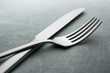 knife and fork on a neutral background
