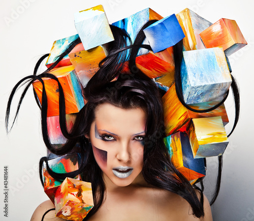 Naklejka na drzwi close-up portrait of beautiful young girl with cubes on head.