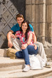© CandyBox Images - Young couple sitting on building steps smiling