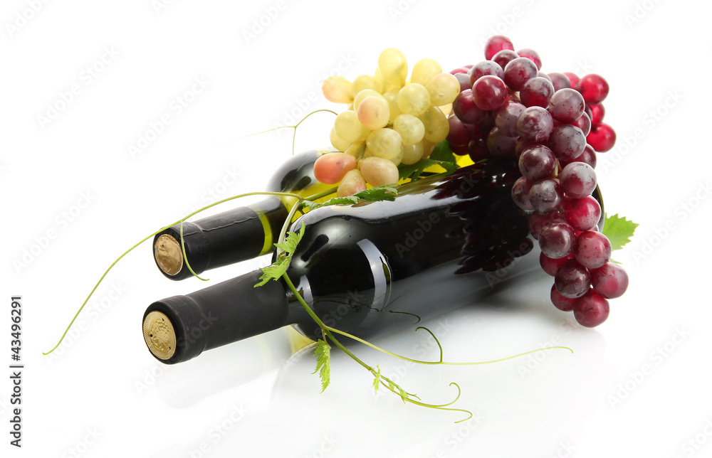 bottles of wine and ripe grapes isolated on white