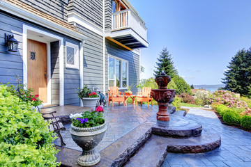 Front of the blue luxury house exterior with fountain.