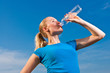 © listercz - young female athlete drinkig water to refresh during a training