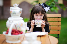 Elegant Child Girl Having A Tea Party Outdoors
