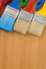 Wall Mural - colorful paintbrush on wood background