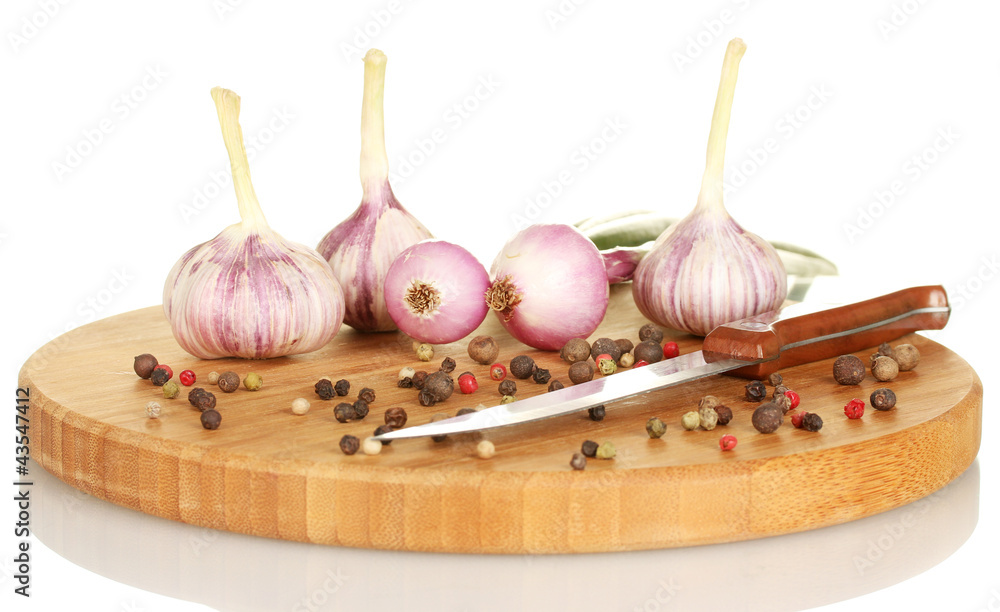 young onion and garlic on a cutting board isolated on white