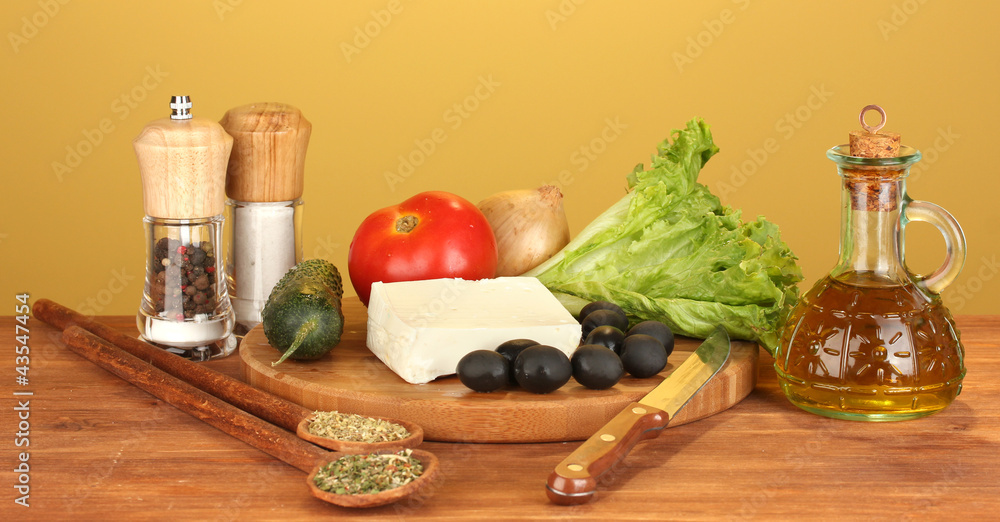 Ingredients for a Greek salad on brown background close-up