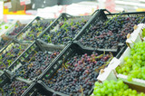 Fototapeta Tulipany - Bunch of fresh red grape in boxes in supermarket