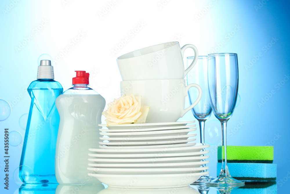 empty clean plates, glasses and cups with dishwashing liquid