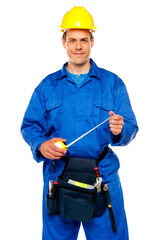 Smiling male worker wearing yellow safety hat