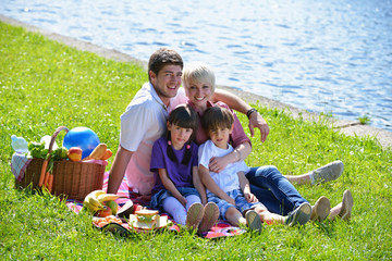 Wall Mural - Happy family playing together in a picnic outdoors