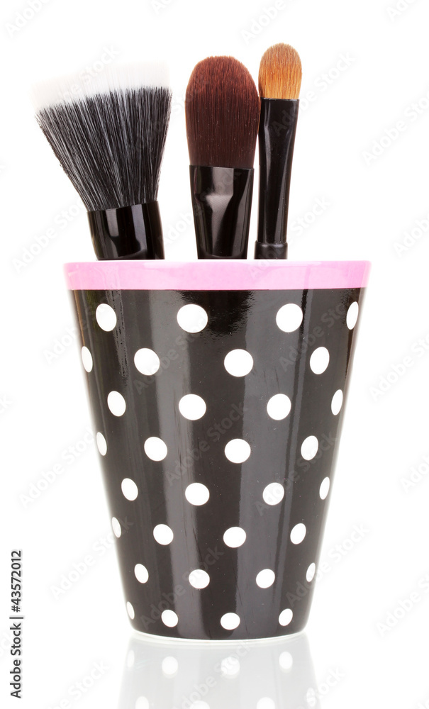 Cosmetic brushes in cup isolated on white