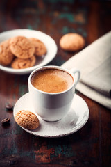 Wall Mural - Cup of espresso and biscotti on dark wooden table