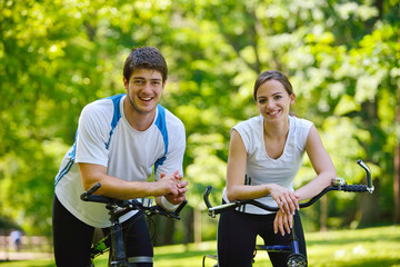 Wall Mural - Happy couple riding bicycle outdoors