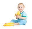 © Andrey Kuzmin - happy child eating healthy food fruits isolated on white