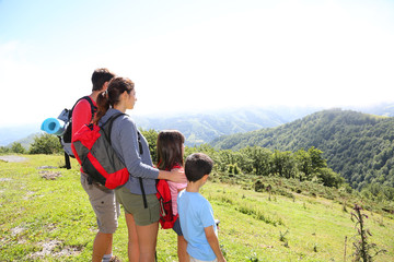 Wall Mural - Family on a trek day in the mountain looking at the view