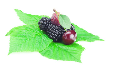 Wall Mural - Raspberries, blackberries,cherry and green leaves on white backg