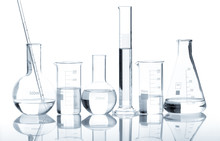 Group Of Laboratory Flasks With A Clear Liquid, Isolated
