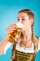 Wall Mural - Junge Frau in traditionellem Dirndl oder Tracht