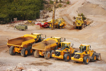 Large Lorry Trucks And Tractors In A Quarry