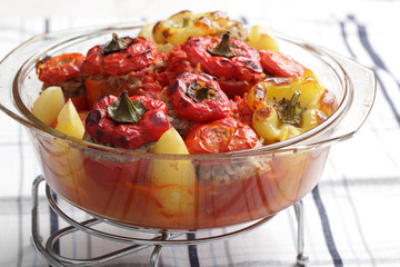 Stuffed tomatoes and peppers in the glass casserole