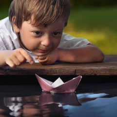 Wall Mural - paper ship in children hand