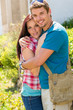 © CandyBox Images - Young happy couple embracing in sunny park