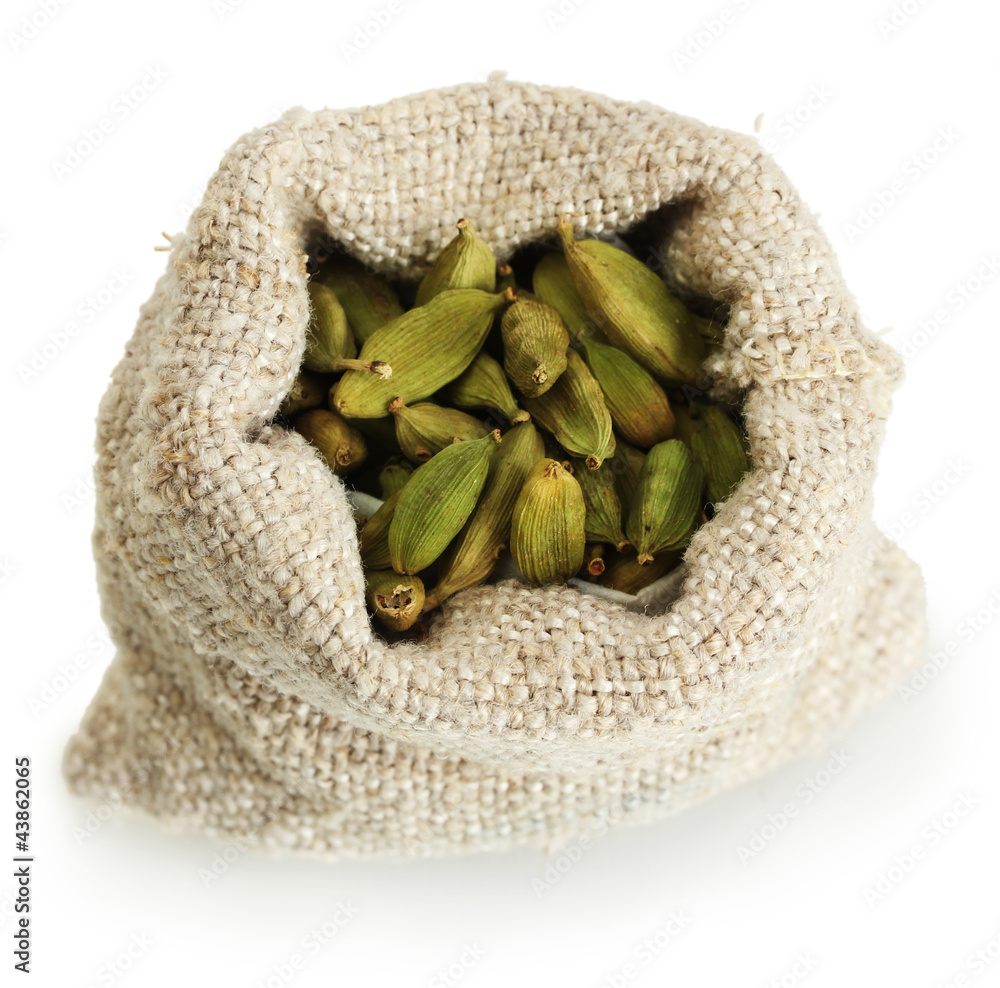 Green cardamom in sack isolated on white close-up